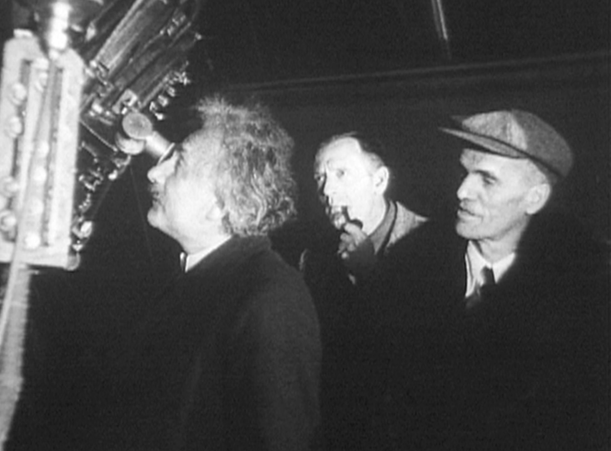 Albert Einstein at the eyepiece of the 100-inch Hooker telescope, accompanied by Edwin Hubble and Walter S. Adams, Mount Wilson Observatory, January 1931.